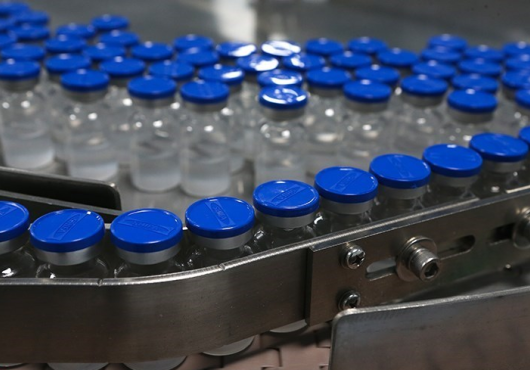 Production line of unlabeled vaccine bottles