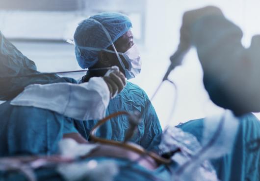 Surgery taking place in a busy operating room.