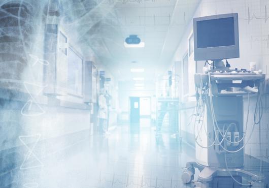 Translucent images of ECG chart and a chest x-ray image superimposed on a brightly lit hospital corridor