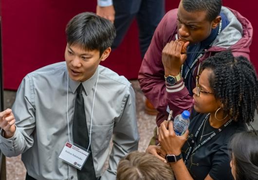 HMS PhD student describing his project to other students