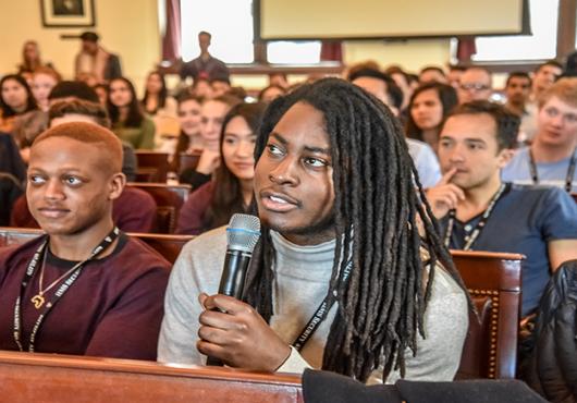 Audience at Amos Lecture. Student asks question into microphone.