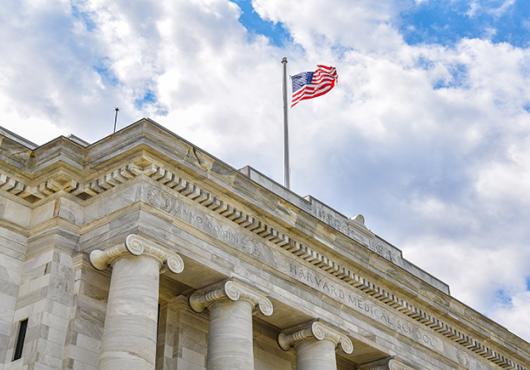 American flag flying above Gordon Hall on the HMS Quad. Image: Steve Lipofsky