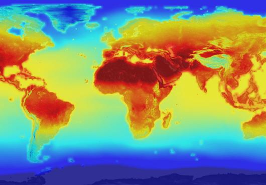 A false color map of the world with red, yellow and orange indicating temperature change due to greenhouse gas emissions.