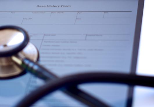 A stethoscope on a case history form