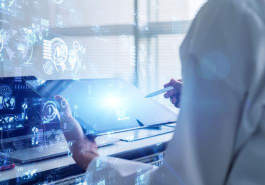 Scientist in white coat holding a table with science concept images overlaid