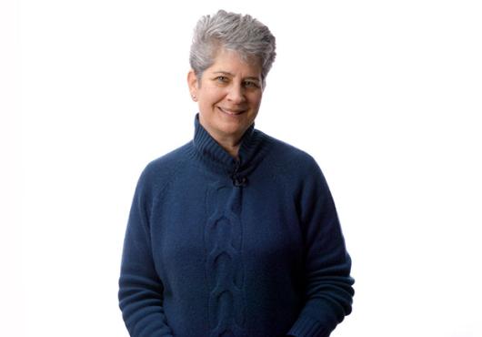 Caroline Shamu stands in front of a white background