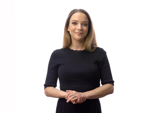 Lauren Orefice stands in front of a white background