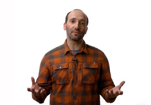Man in a collared shirt, gesturing
