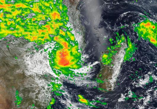 A satelite image of a swirling storm above Malawi and Madagascar, with bands of green, yellow, orange and red showing increasingly intense rainfall.