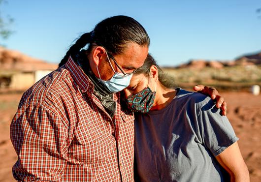 A husband and wife comfort one another during the Coronavirus shutdown on the Navajo nation in Arizona