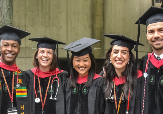 Image of happy graduates standing together