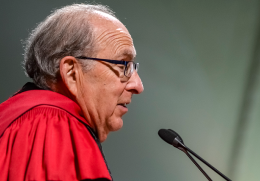 Dean Donoff for Harvard School of Dental Medicine in front of microphone