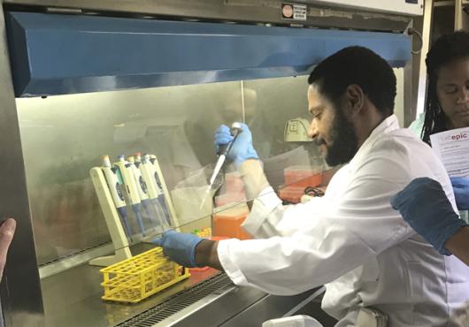 Man with pipette while others look on