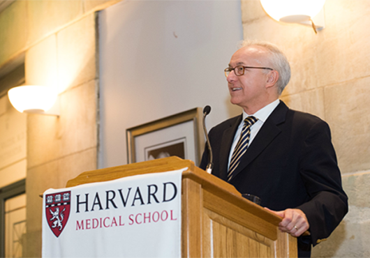 George Q. Daley speaks to an audience. 