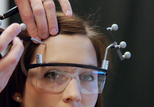 A scientist scans a woman's brain