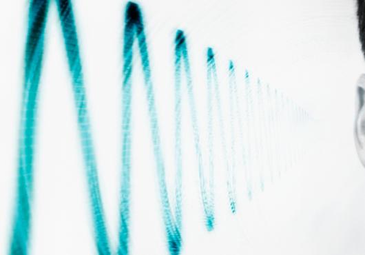 photo of side of man's head showing sound wave near ear