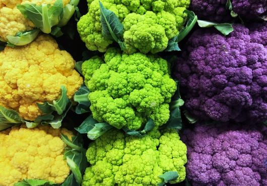 Brightly colored cauliflower crowns--yellow, green, purple