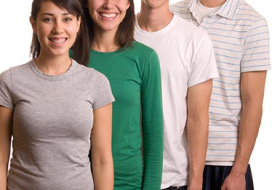 four young people stand close together. their heights rise by a few inches with each person