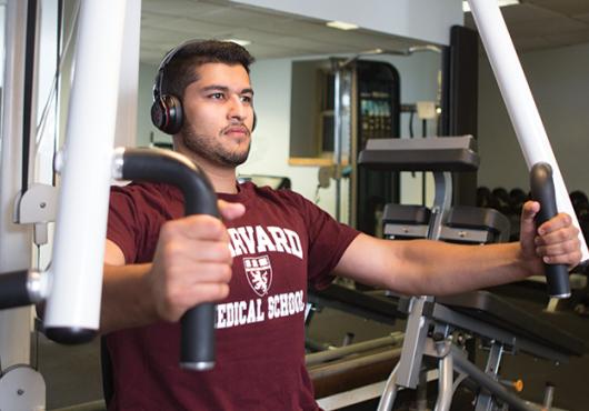 photo of Zaki lifting weights on a chest press machine