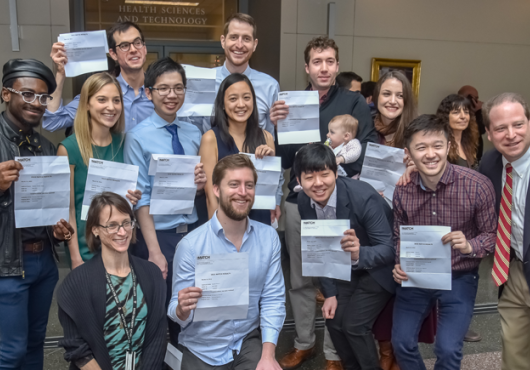 Group of happy HMS Students holding up their Match Day letters.