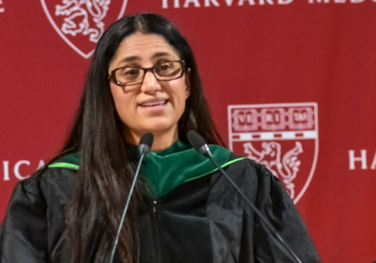 Mona Hanna-Attisha infront of the podium addressing the crowd