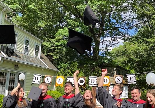 Grads tossing mortarboards