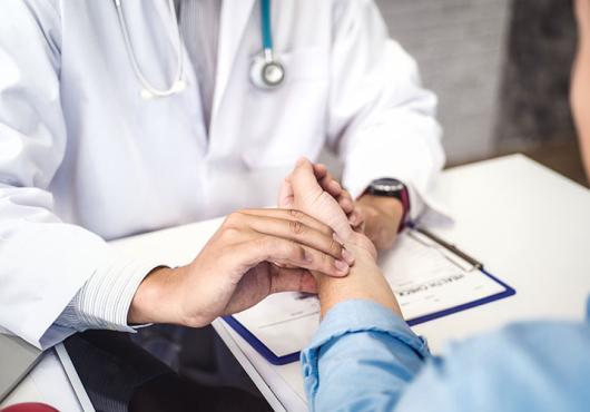 A physician checks a patient's pulse