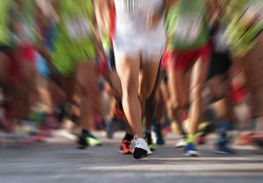 blurred image of runners' legs