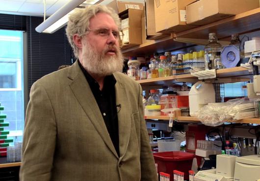 George Church stands in a lab
