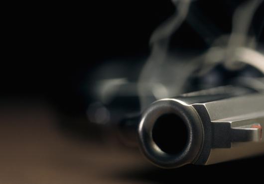 Smoking handgun on a table.