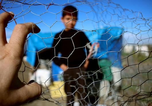 child behind fence