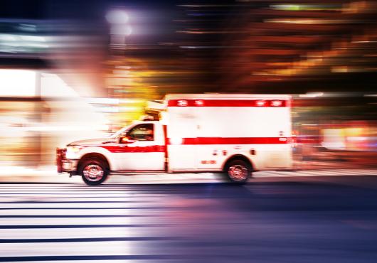 Ambulance speeding at night with motion blur