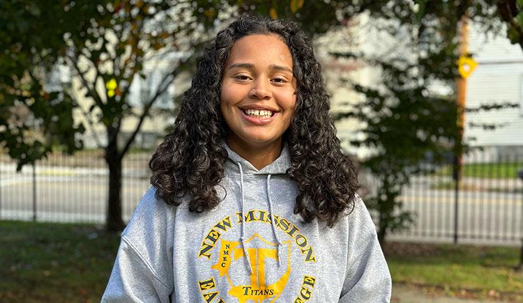 Jasmine Canas smiling, wearing her high school's sweatshirt
