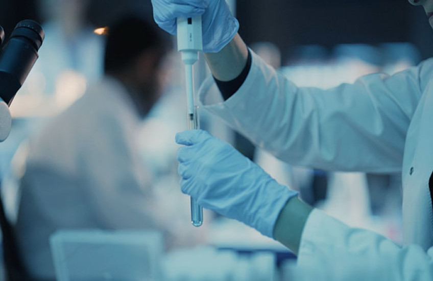 researcher in white coat working in laboratory