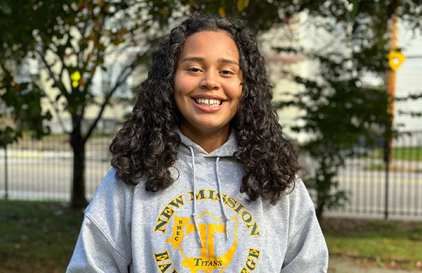 Jasmine Canas smiling, wearing her high school's sweatshirt