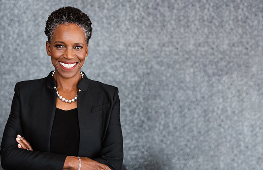 head shot of Melissa Gilliam, a middle-aged Black woman with a bright smile, slightly graying hair, dark blazer, and pearl necklace