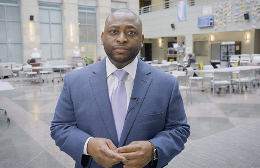 Dixon in blue suit in the TMEC Atrium