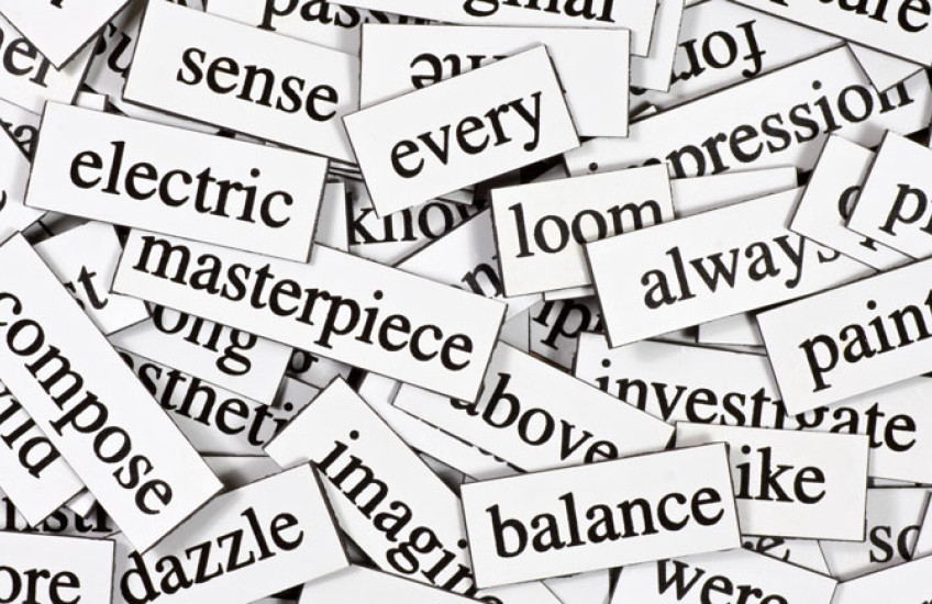 A pile of black words on rectangular white magnets