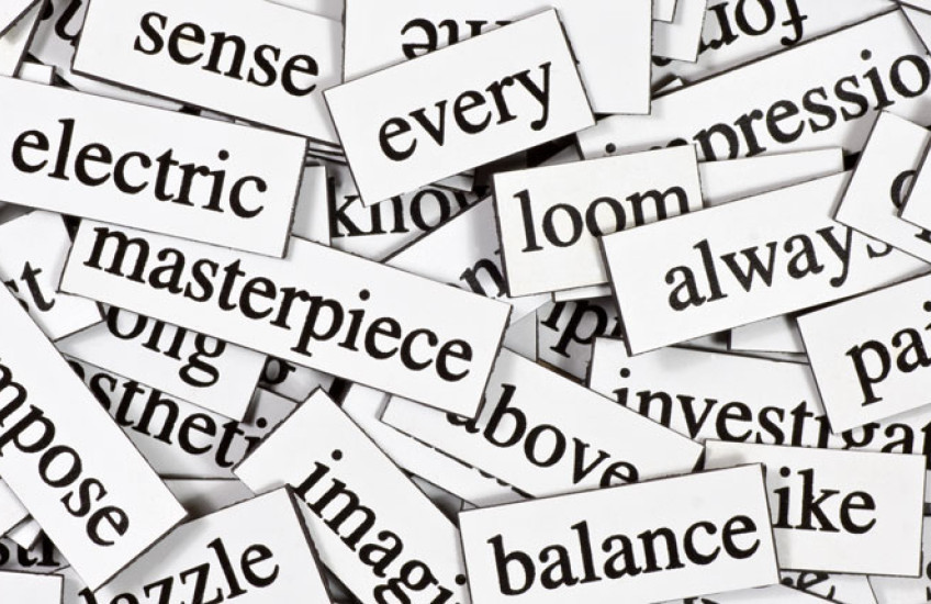 A pile of black words on rectangular white magnets
