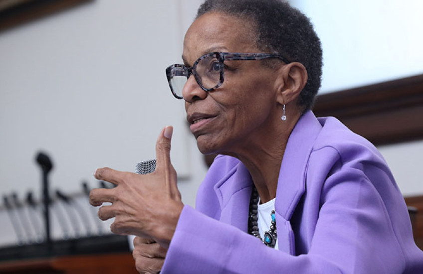Photo of Joan Reede speaking at a podium