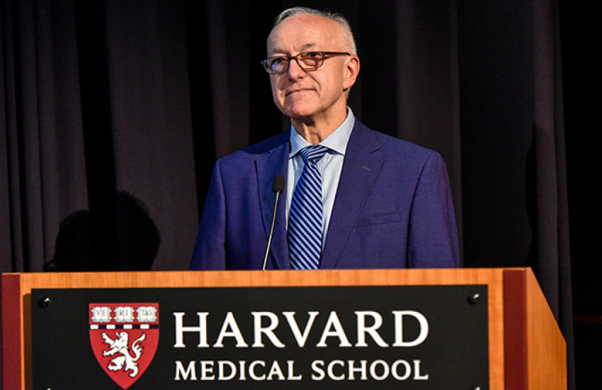 Dean George Q. Daley stands behind a Harvard Medical School podium