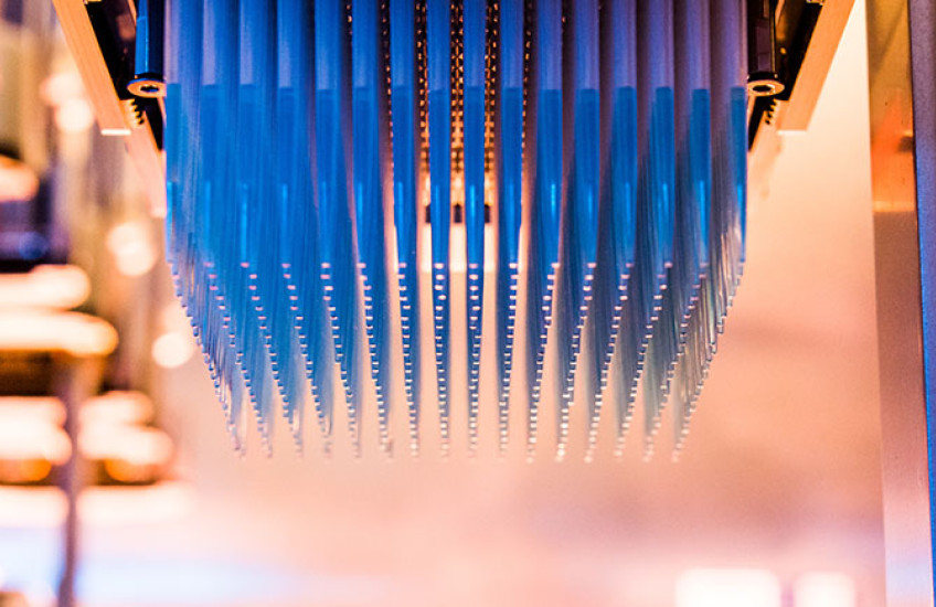 Narrow pipettes hanging upside down from a high-throughput screener