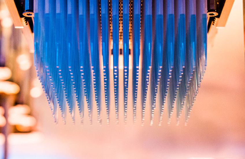 Narrow pipettes hanging upside down from a high-throughput screener