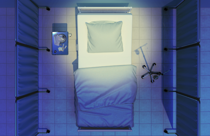 Overhead view of an empty hospital bed with blue sheets, surrounded by privacy screens, with an IV stand on one side and a small table with supplies on the other.