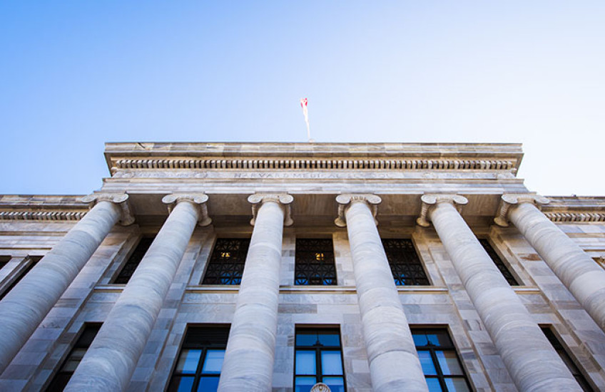 A view of Gordon Hall, looking up the columns to the roof and sky above