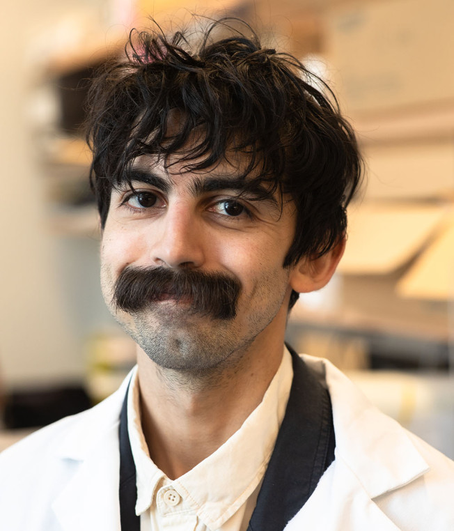 Portrait photo of Dionnet Bhatti Mazo in a white lab coat.