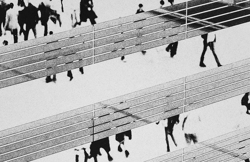 abstract, grayscale image of people walking
