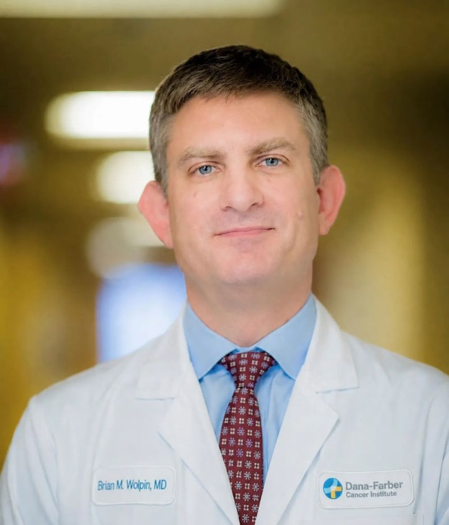 Alt text: Portrait photo of Brian Wolpin in a white coat.