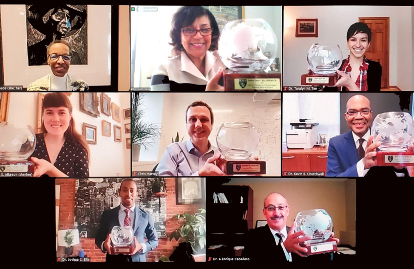 : Portraits of eight people smiling, with seven award winners holding commemorative crystal bowls. 