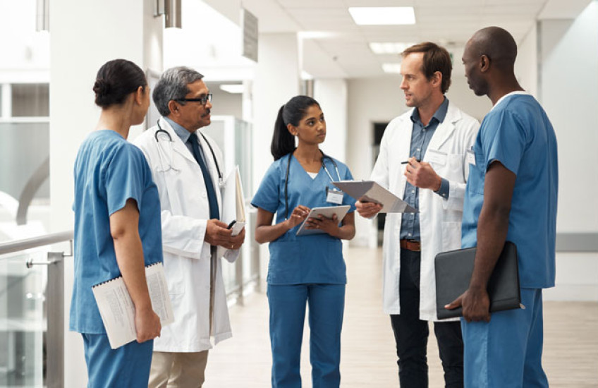 Doctors talking in a group in a hospital 